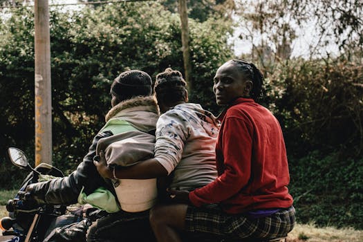 A family takes a motorcycle ride in Nairobi, showcasing daily life and transportation in Kenya.