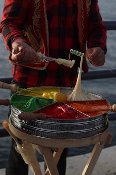 Street vendor prepares colorful Turkish candy on a waterfront in Istanbul.