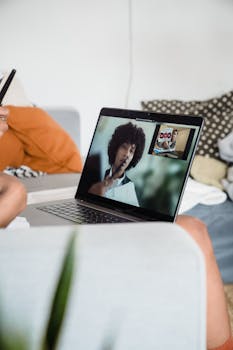 Close-up of a laptop screen during a video conference, showcasing remote work setup.