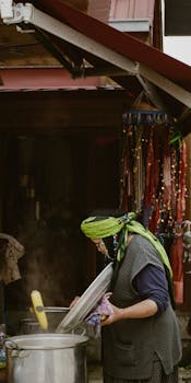 Woman stirring a pot in Rize, Turkey, showcasing traditional cooking methods.